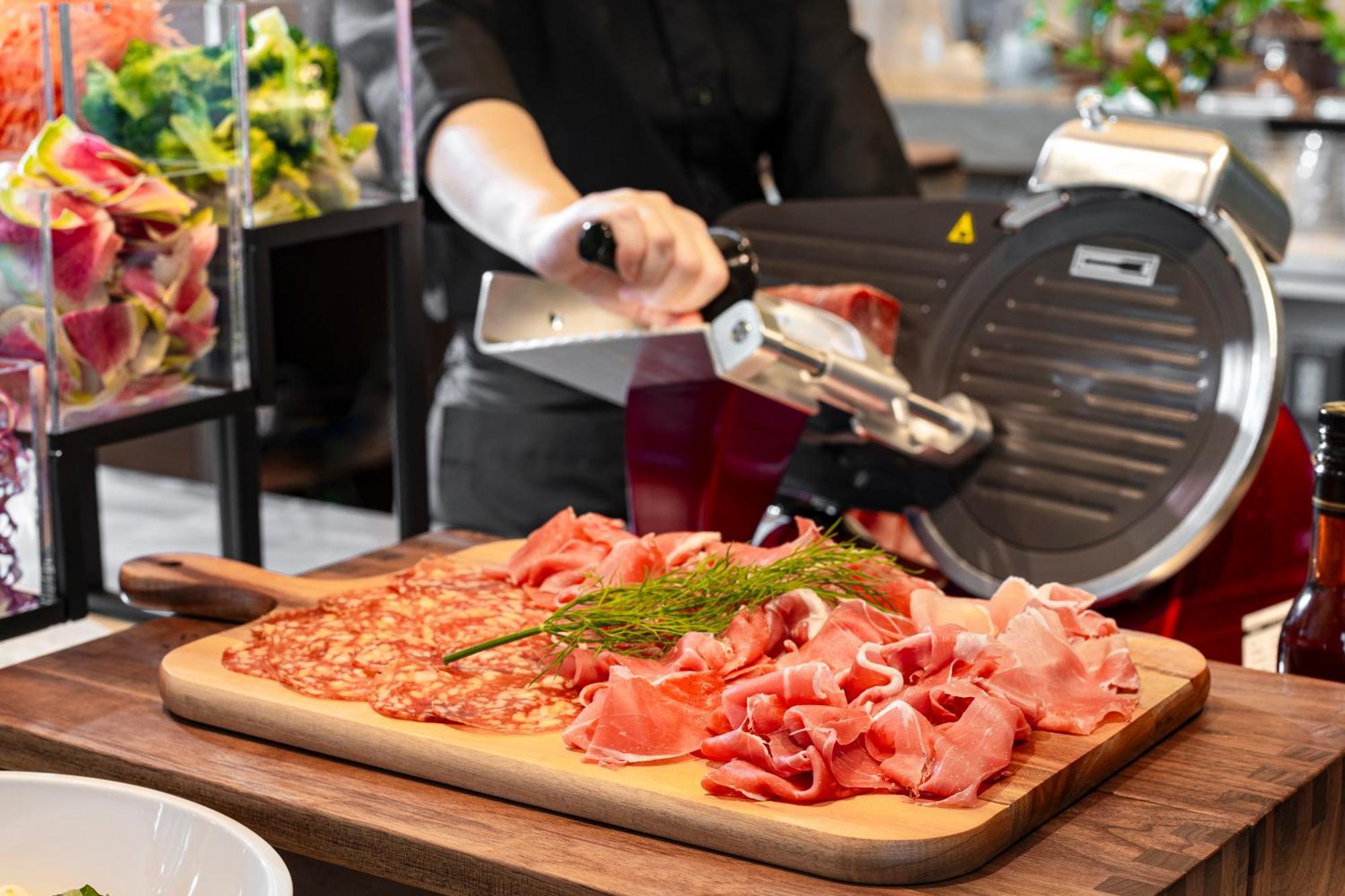 Candeo Hotels Osaka The Tower Exterior photo A deli slicer in action